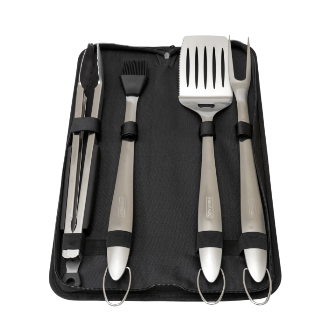 Stainless steel BBQ grill tool set with black zippered carrying case — 4-piece Fire Magic set including tongs, basting brush, slotted spatula and carving fork