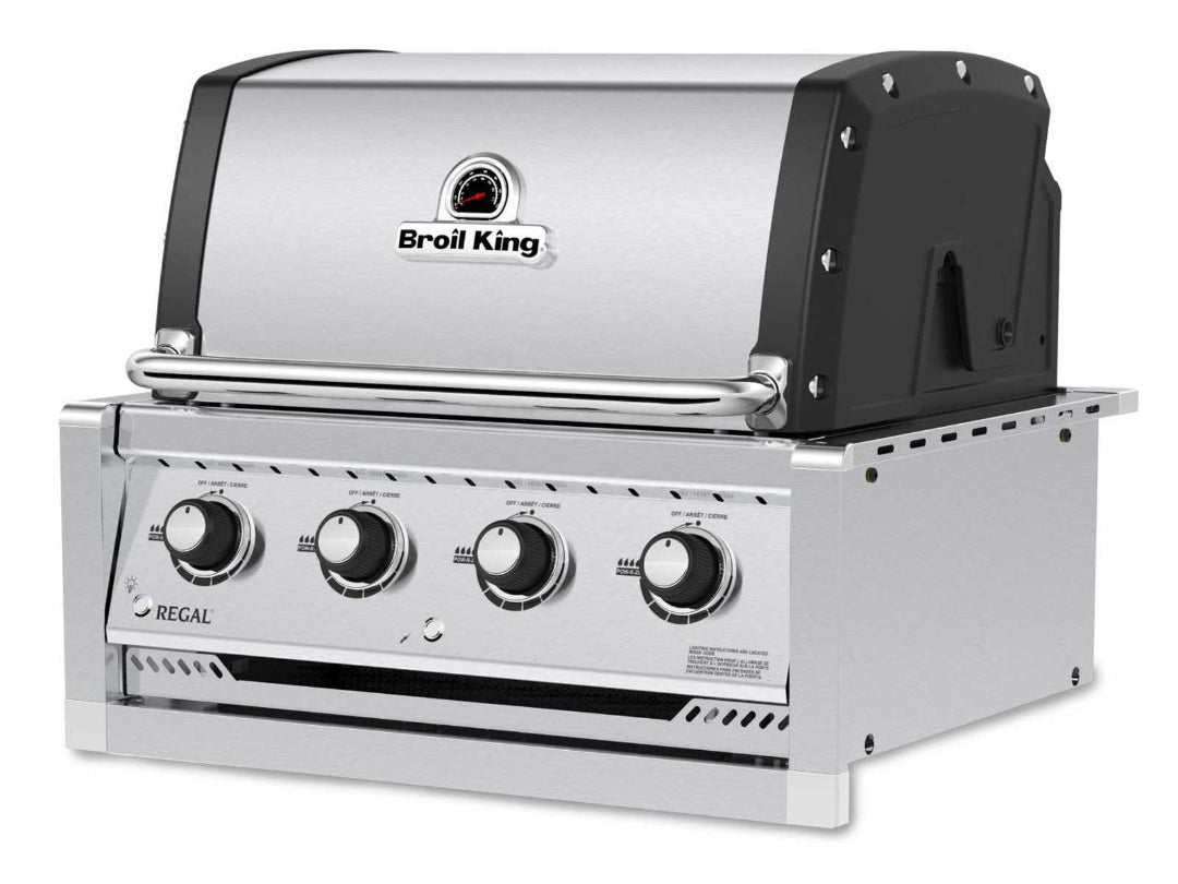 Broil King Regal built-in gas grill angled side view, stainless steel hood, four burner control knobs, and black side panels