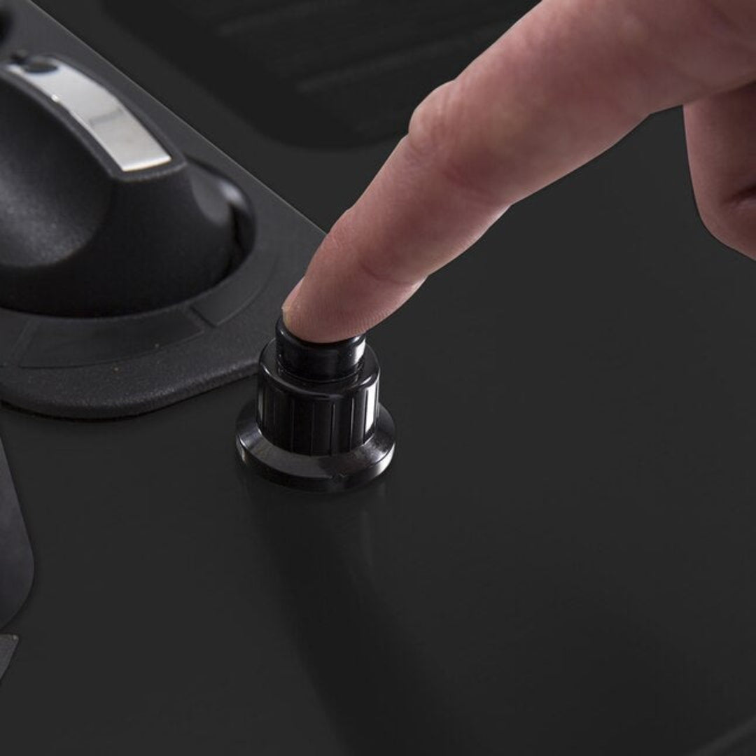 Ignition button, Broil King portable grill igniter with finger pressing down for startup