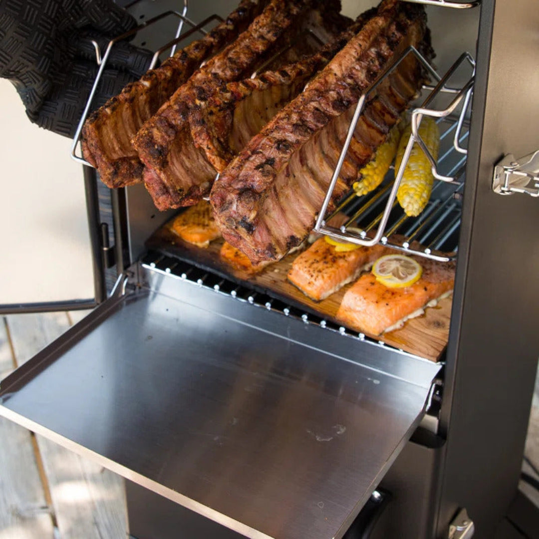 Vertical smoker, Broil King, Smoke Series, interior racks with ribs, salmon, and corn on stainless steel prep shelf