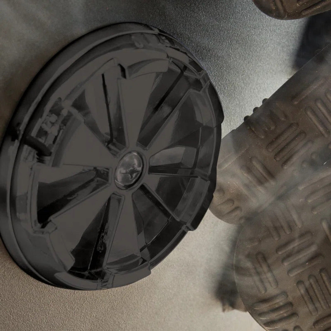 Close-up, Broil King, smoker series wheel, heavy-duty plastic design with textured treads and smoke detailing