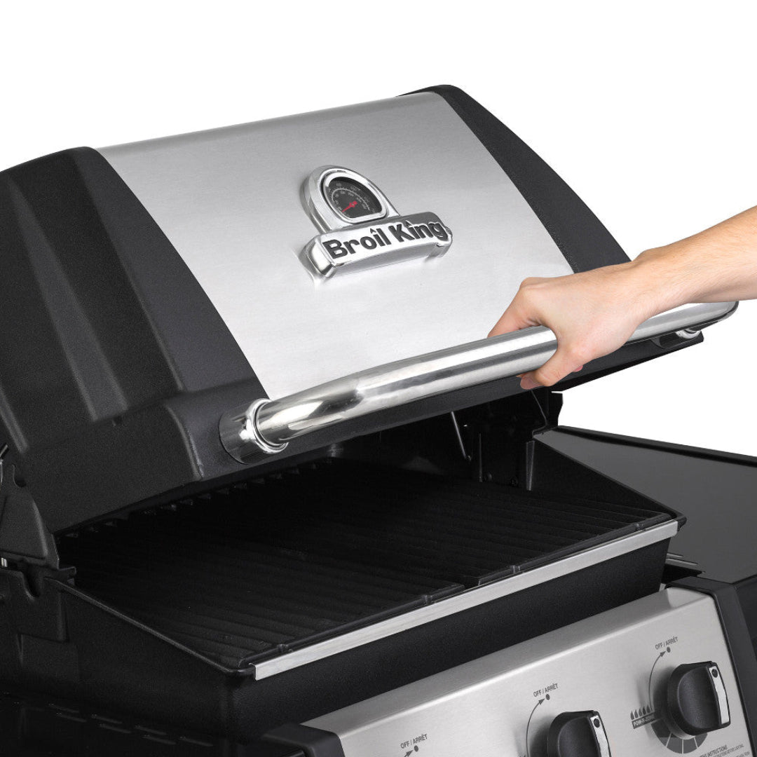 Grill hood, Broil King Signet, stainless steel lid with thermometer and control knobs visible
