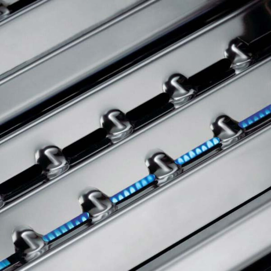 Gas grill burners, Broil King, stainless steel construction, blue flame ignition, close-up angle