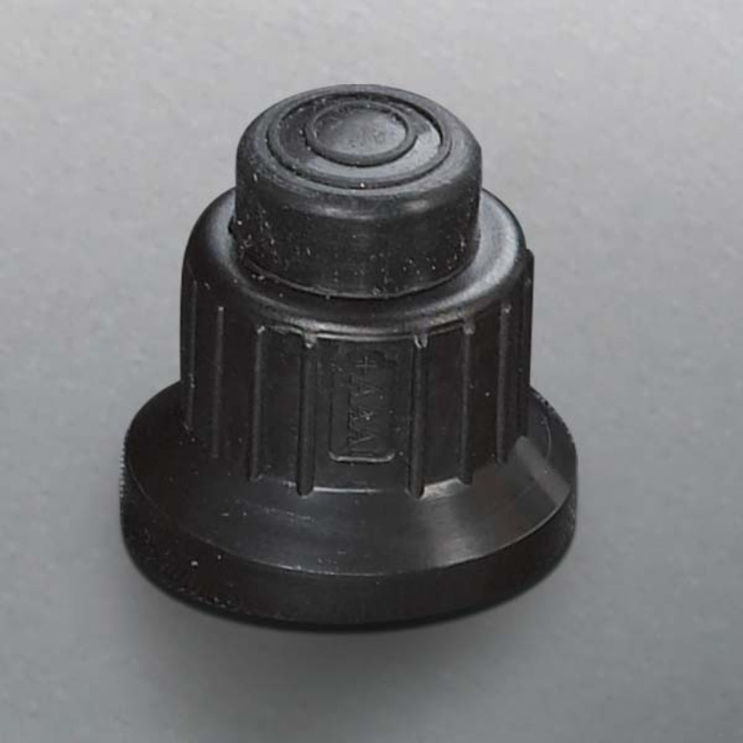 Control knob, Broil King, black plastic, push-button ignition, ribbed grip, isolated on gray background