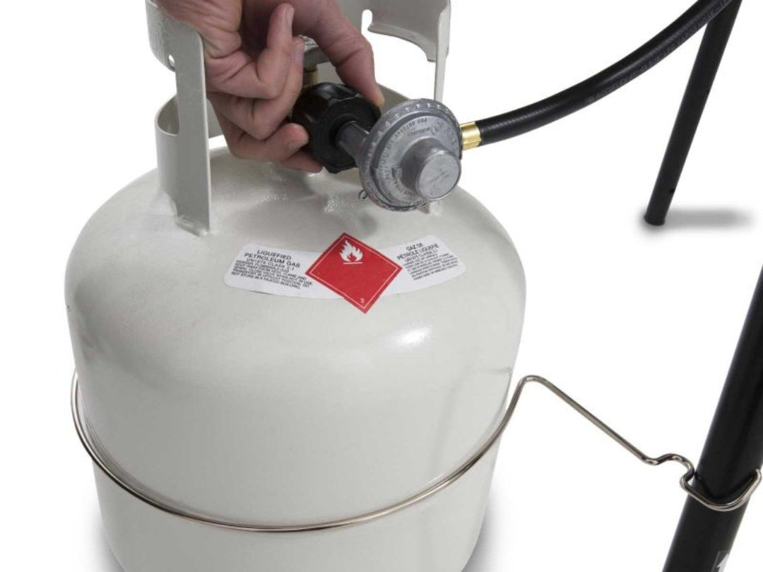 Propane tank connection, Broil King gas grill, close-up of regulator hose attachment, fuel setup process