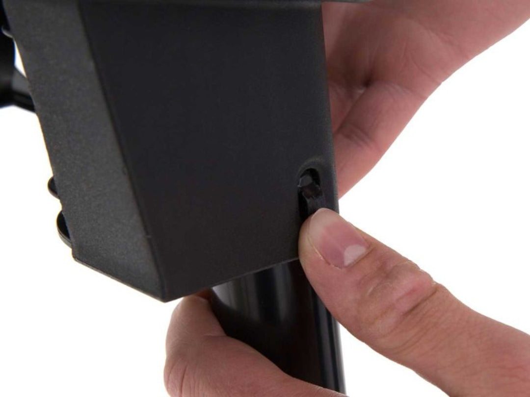 Broil King grill leg locking mechanism, portable gas grill, close-up of leg pin insertion, grill setup detail