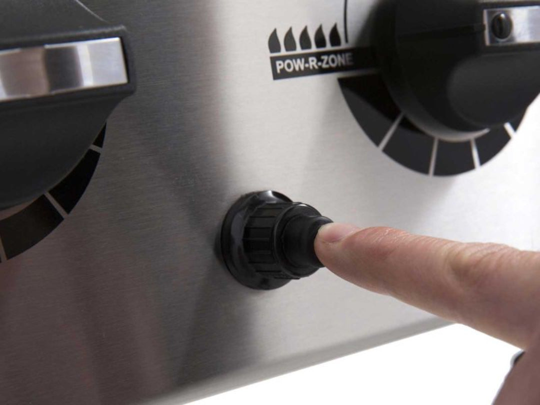 Bamboo grilling skewers with bacon-wrapped beef and pineapple cooking on flat-top griddle being basted with herb sauce from stainless-steel saucepan