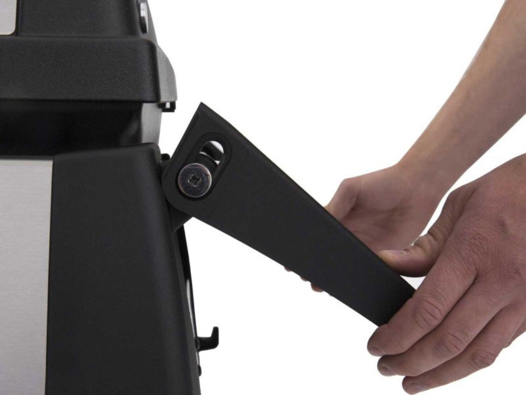 Foldable side shelf, Broil King gas grill, hands adjusting collapsible support arm, grill storage feature