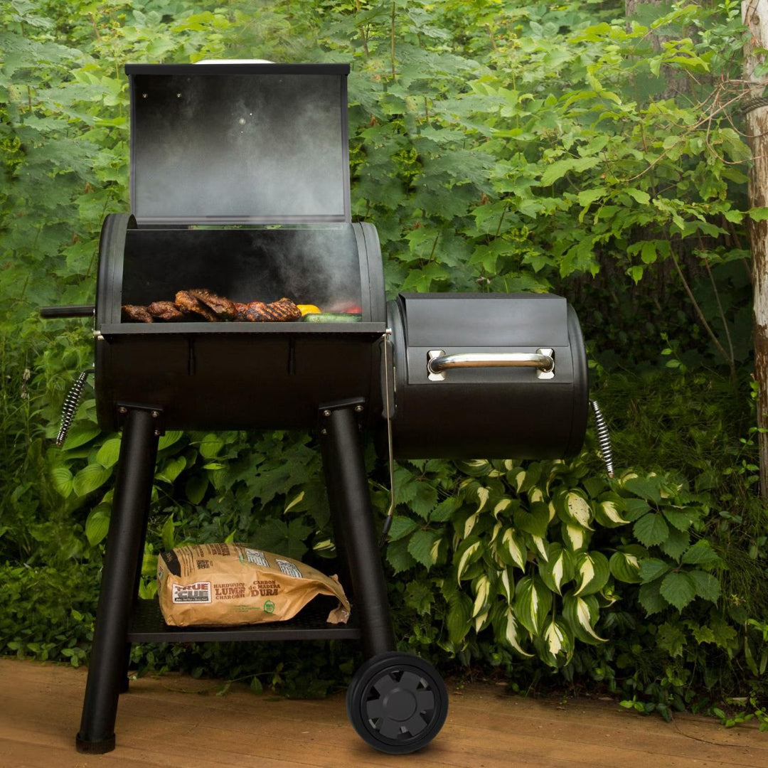Offset Smoker, Broil King, Smoke Series, Outdoor Grilling in Lush Backyard with Open Lid and Charcoal Storage