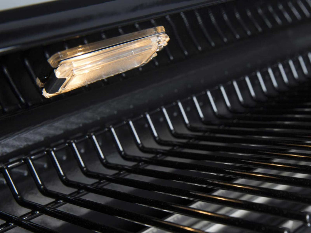 Broil King interior grill light illuminating stainless steel cooking grates and back hood panel