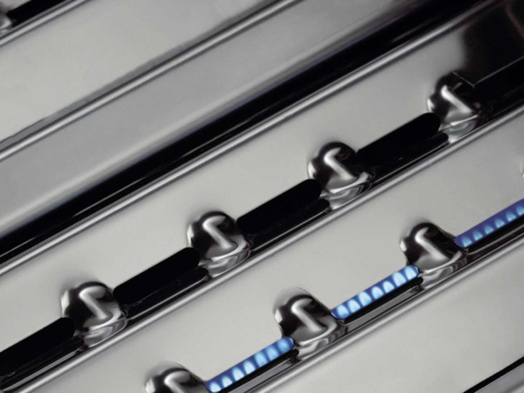 Broil King stainless steel Flav-R-Wave heat plates dispersing blue gas flames