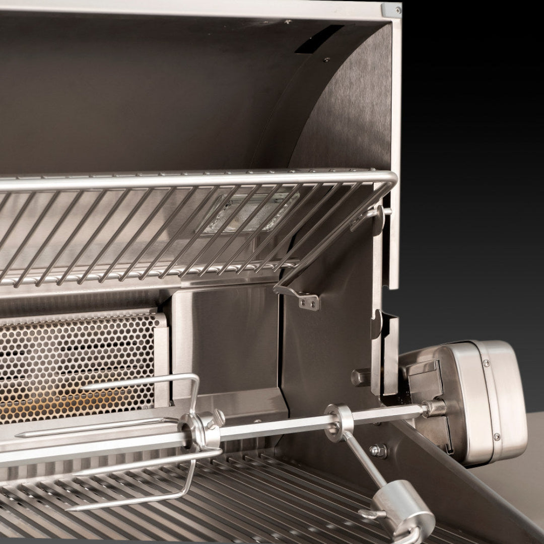 Fire Magic stainless steel built-in gas grill rotisserie kit interior showing motor, stainless spit rod with forks, upper warming rack and cooking grates
