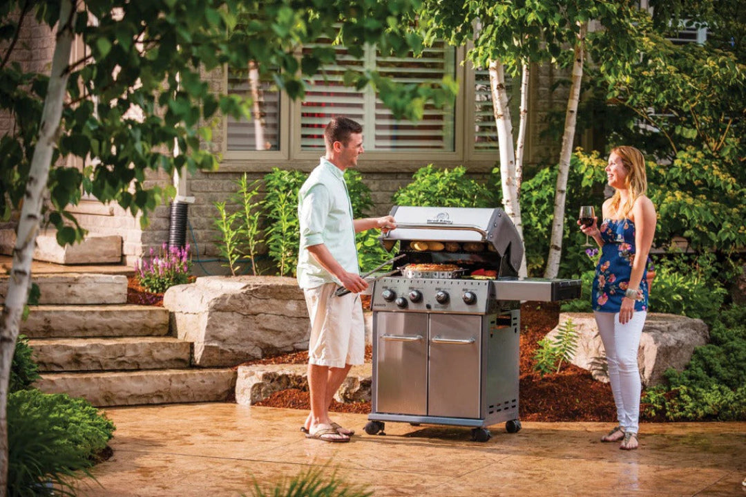 Freestanding Grill – Broil King – Crown Series – Stainless Steel Grill with Couple Cooking Outdoors