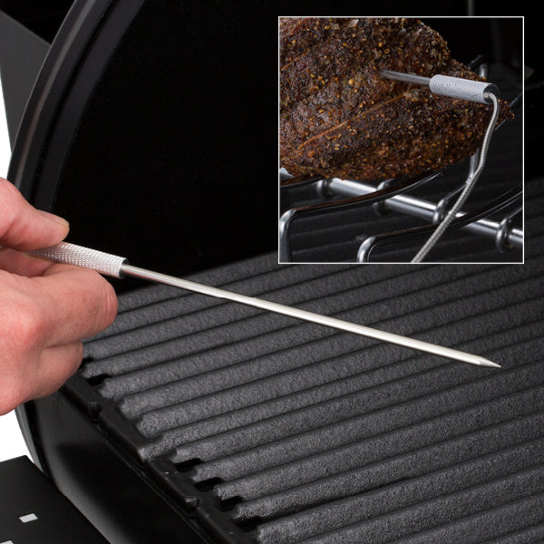 Grill accessory, Broil King, Regal series, temperature probe being inserted into meat over cast iron grates