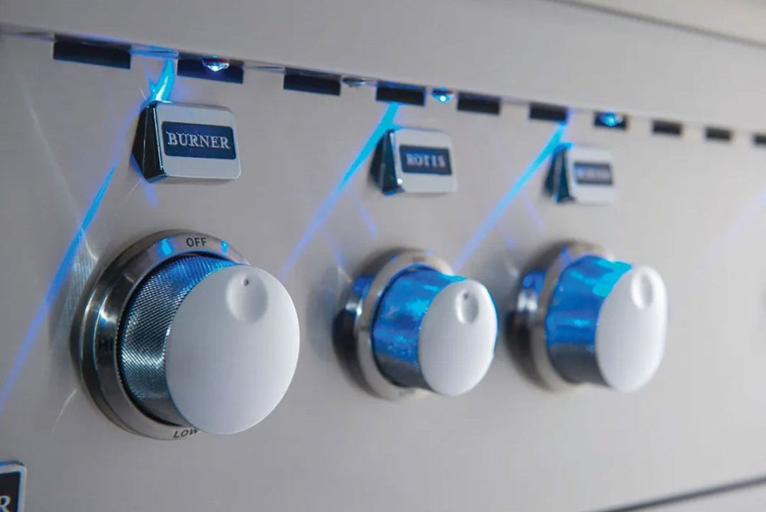 Broilmaster BSG343N1 34-inch 3-burner built-in stainless steel natural gas grill close-up of illuminated white control knobs with blue LED lighting