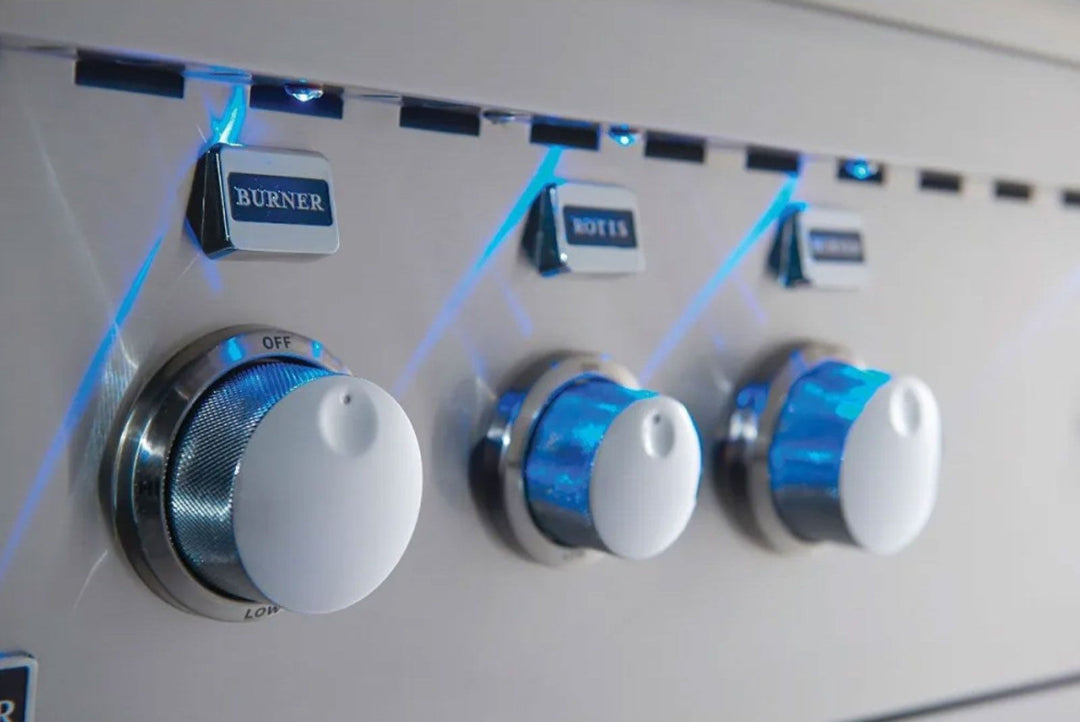 Broilmaster B-Series BSB324N 32-inch 4-burner stainless steel natural gas grill control panel close-up with blue LED illuminated burner knobs