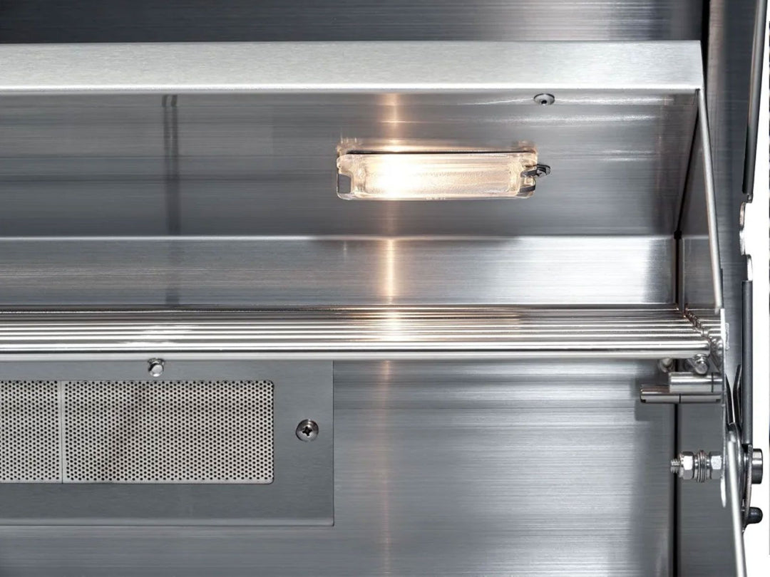 Broilmaster B-Series 32-inch BSB324P 4-burner stainless steel propane grill interior showing under-hood light, stainless warming rack, vent panel and hinge assembly