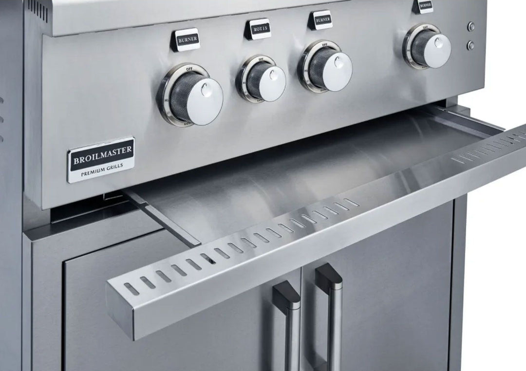 Broilmaster B-Series 40-inch 5-burner stainless steel natural gas grill BSB405N close-up of control panel with stainless knurled knobs, Broilmaster badge, pull-out grease tray and double-door storage cabinet for outdoor kitchen
