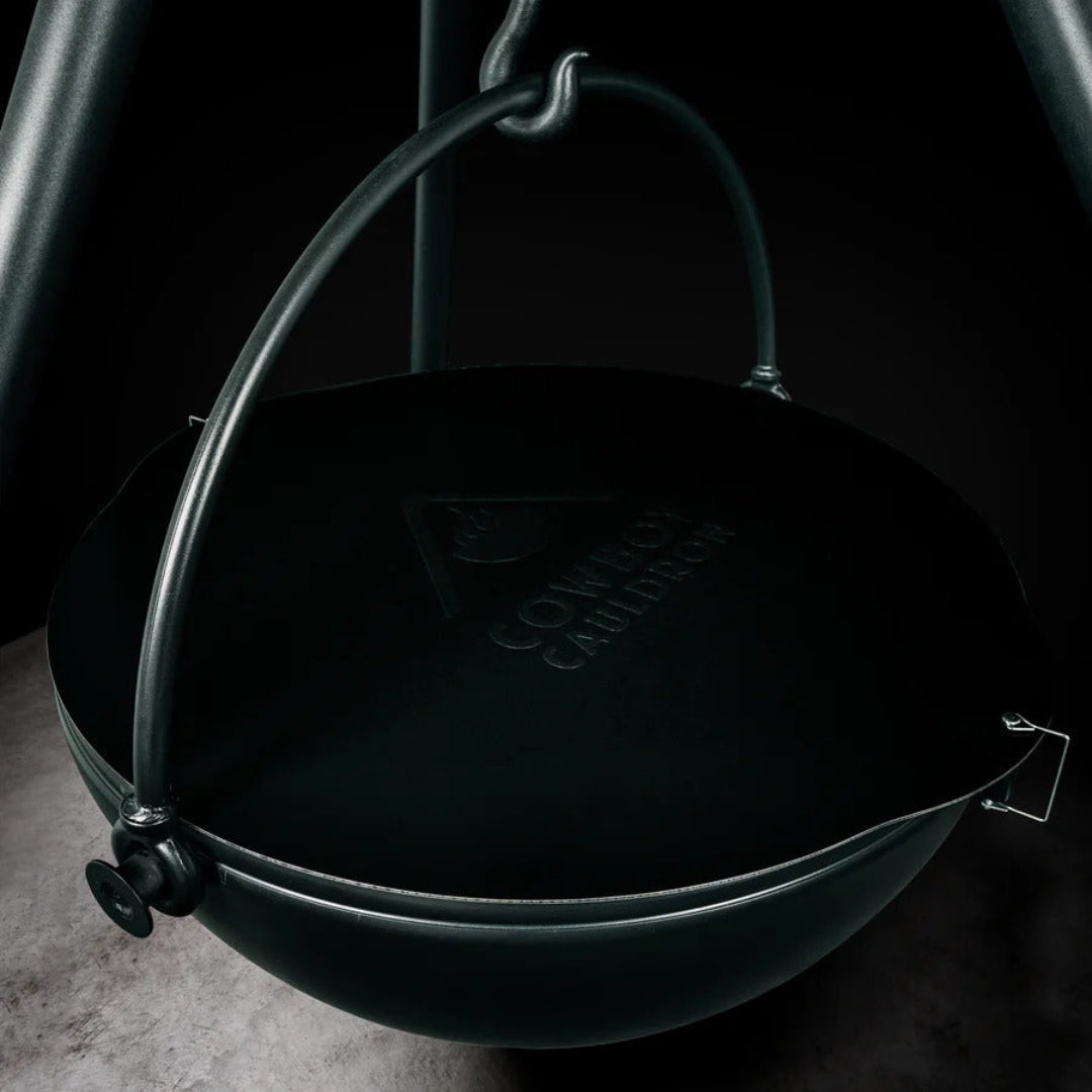Cowboy Cauldron CC-530013 cast iron hanging cauldron with lid and bail handle on tripod for campfire cooking