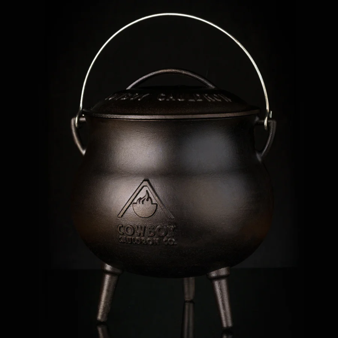Cowboy Cauldron Chuckwagon Cook Pot CC-90018 — three-legged cast iron campfire cauldron with lid and bail handle, embossed logo; outdoor cooking pot for camping stews, chili and chuckwagon recipes