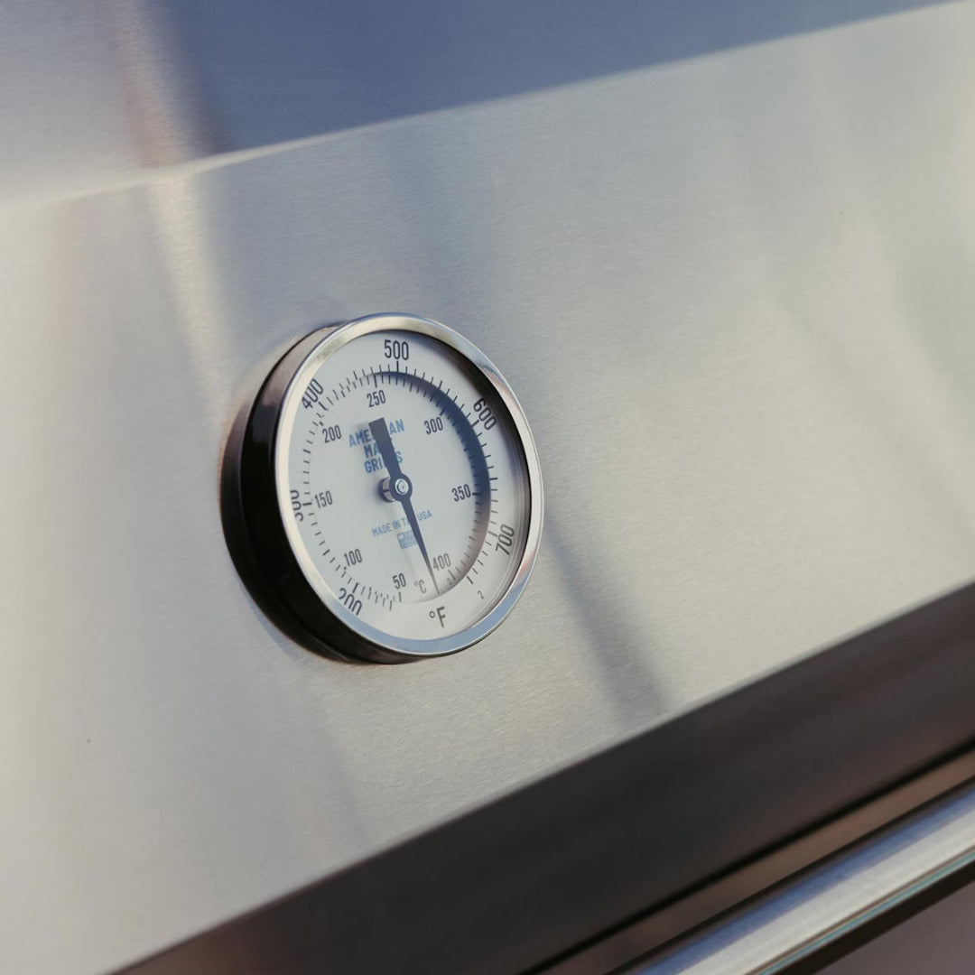 Close-up of built-in temperature gauge on American Made Grills Encore 36" natural gas grill hood