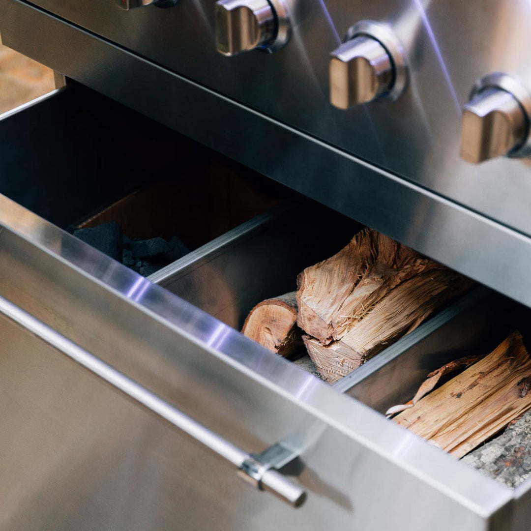 Fuel drawer of the American Made Grills Encore 54" LP grill with separate charcoal and wood storage compartments