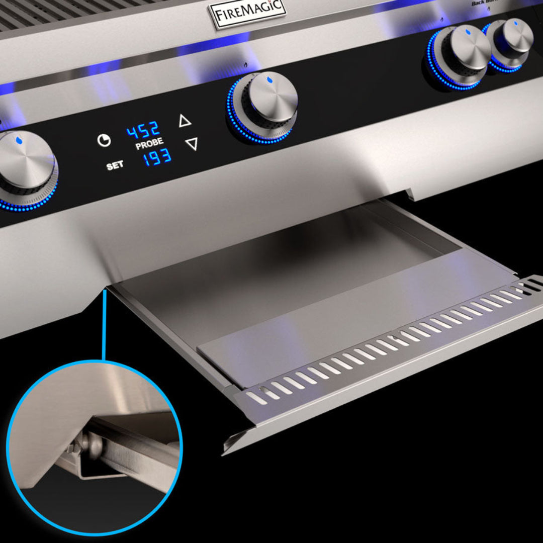 FireMagic Echelon stainless steel slide-out drip tray removable grease drawer with hinge detail under digital probe temperature display and blue LED illuminated control knobs