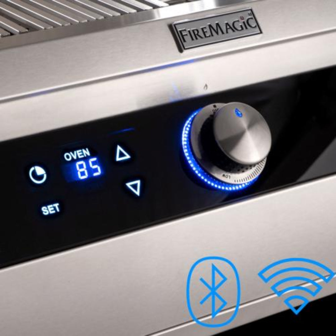 FireMagic Echelon stainless steel grill control panel with digital oven thermometer display reading 85°F, blue LED illuminated rotary knob and Bluetooth/Wi‑Fi connectivity icons — Vine and Flame outdoor kitchen accessory