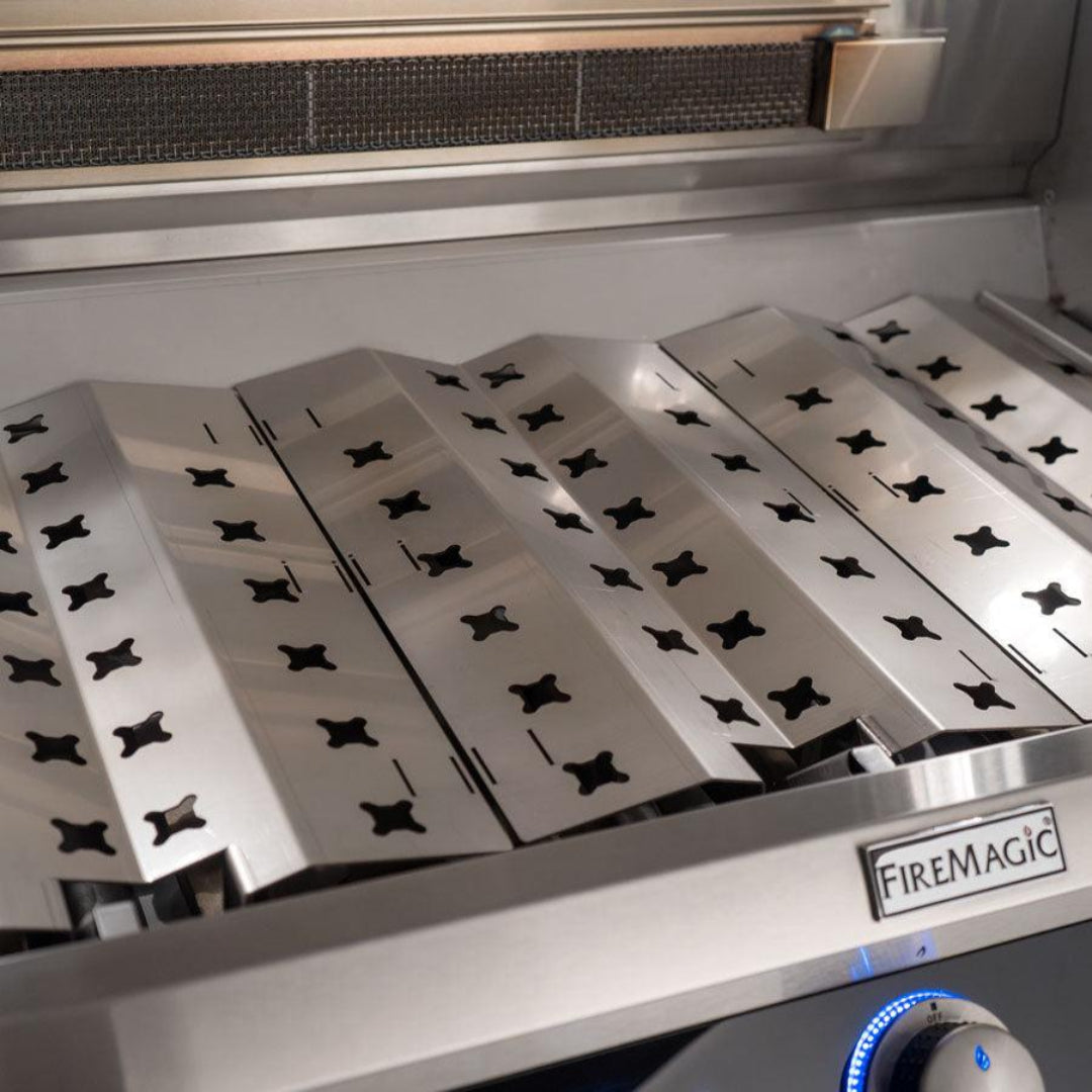 Fire Magic Echelon stainless steel flavor grids replacement set in gas grill, V-shaped flavorizer bars with cross-shaped cutouts and FireMagic logo
