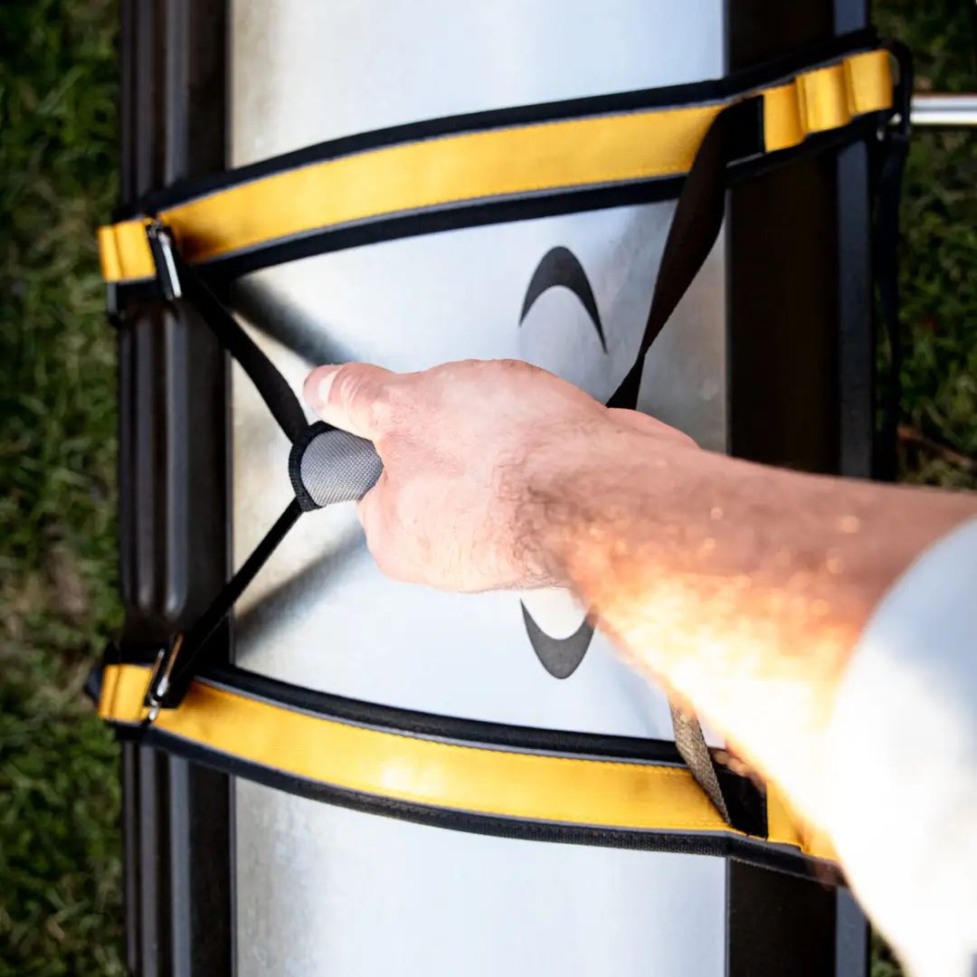 Top-down view of HALO HO-3002 yellow and black appliance carry straps with padded center handle gripped around a silver countertop unit
