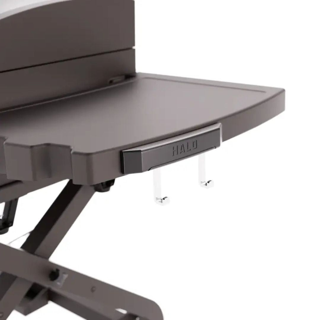Close-up of HALO Elite 3B Griddle side shelf with HALO logo, two metal utensil hooks and folding support legs in dark gray finish