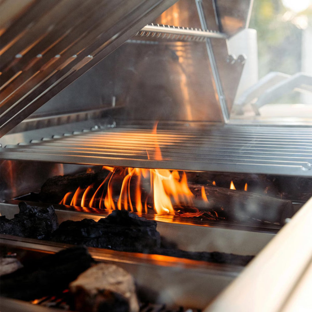 Grill interior, American Made Grills Muscle 54", wood-burning flame under stainless steel grates