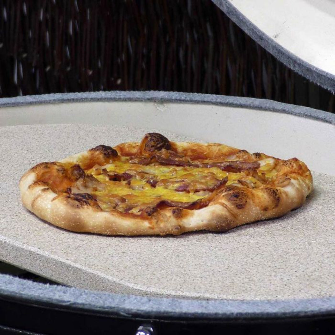 Round pizza baking stone for kamado and ceramic grills with charred-crust pizza