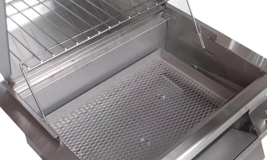 Fire Magic stainless steel charcoal smoker interior showing diamond expanded metal charcoal grate, chrome upper cooking/warming rack and lid prop rod