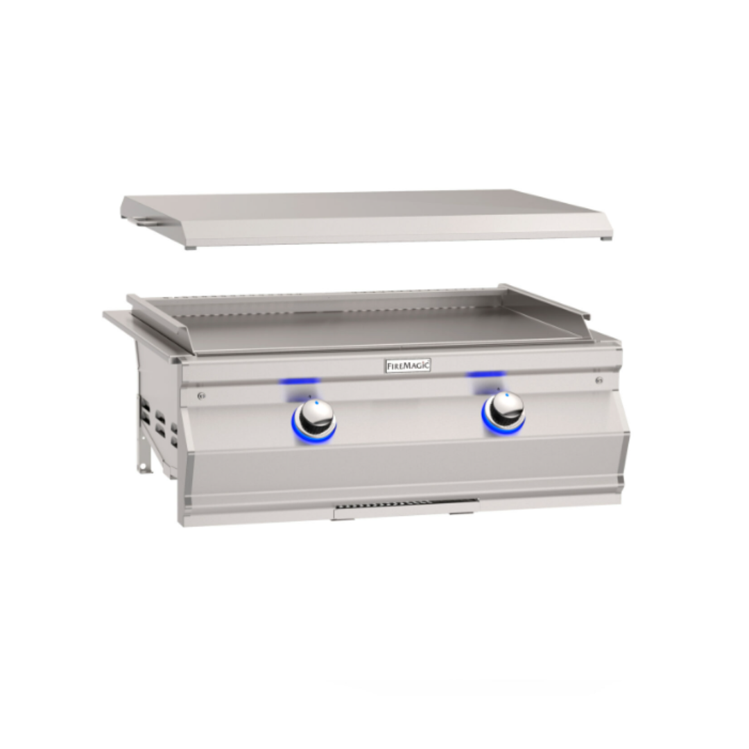 FireMagic Aurora stainless steel built-in flat top griddle for outdoor kitchen with removable hood and blue LED-backlit dual control knobs