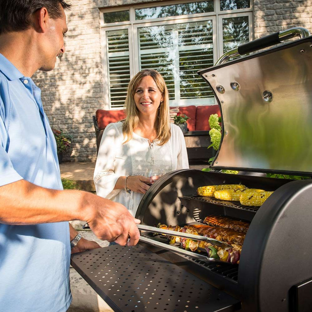 Charcoal grill, Broil King, Smoke Series, grilling corn and skewers, couple enjoying backyard cookout on sunny patio
