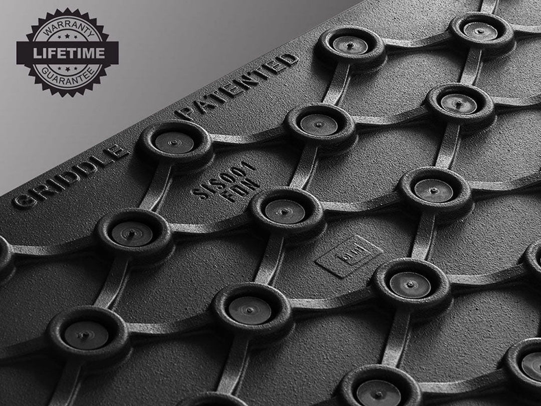 Close-up of a cast iron griddle with a lifetime guarantee label.