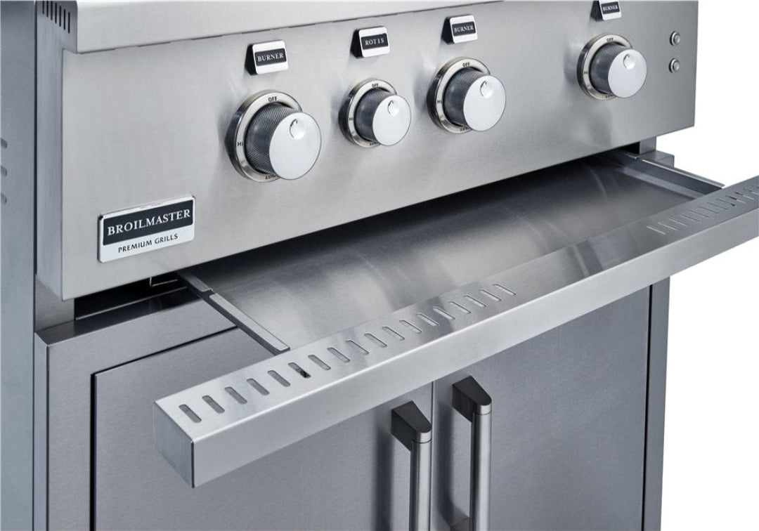Broilmaster BSB405P 4-burner stainless steel built-in gas grill front control panel close-up with knurled burner knobs, pull-out warming drawer and double-door stainless cabinet