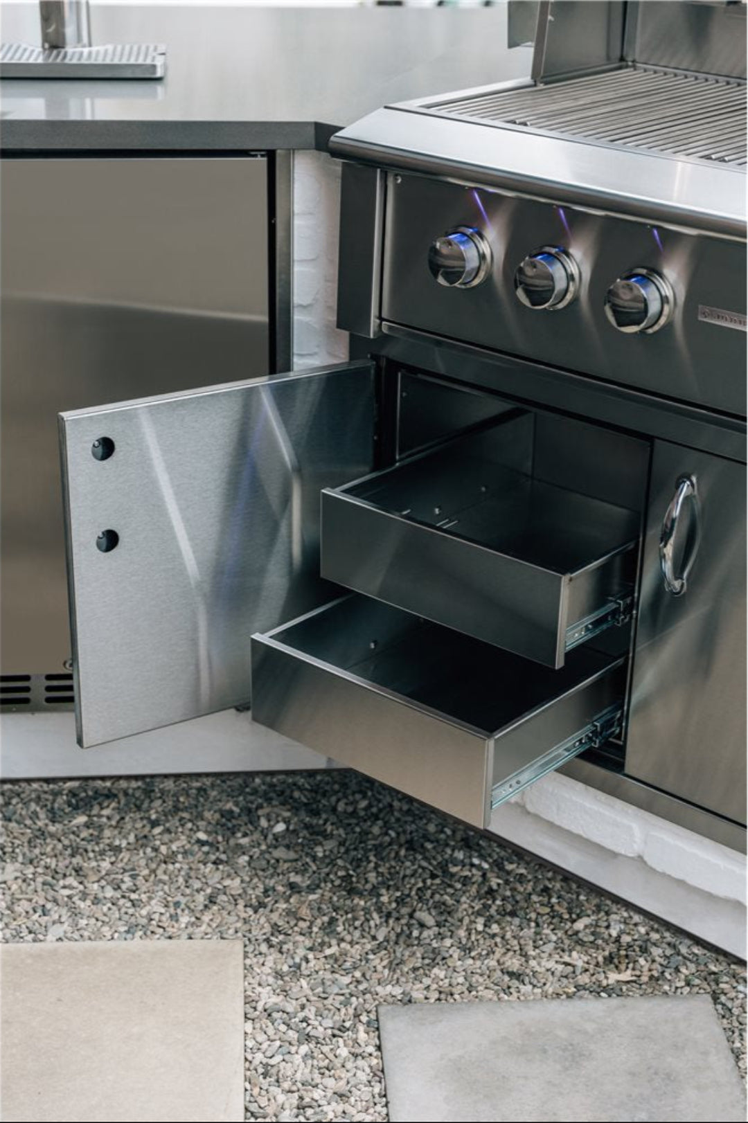 36-inch stainless steel built-in outdoor grill cabinet with two pull-out storage drawers and swing access door beneath 3-burner gas grill