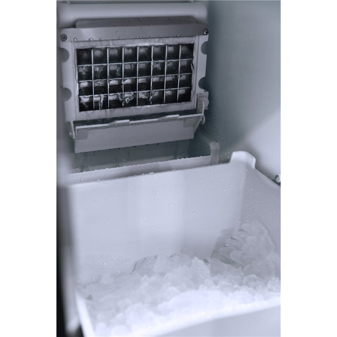 Undercounter built-in automatic ice maker interior with metal ice mold and removable storage bin filled with ice