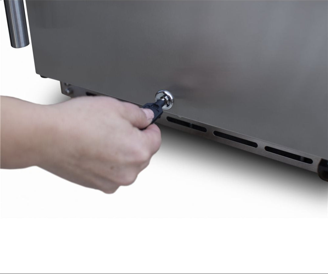 Trueflame TF-RFR-15G stainless steel gas grill grease drain plug being removed by hand