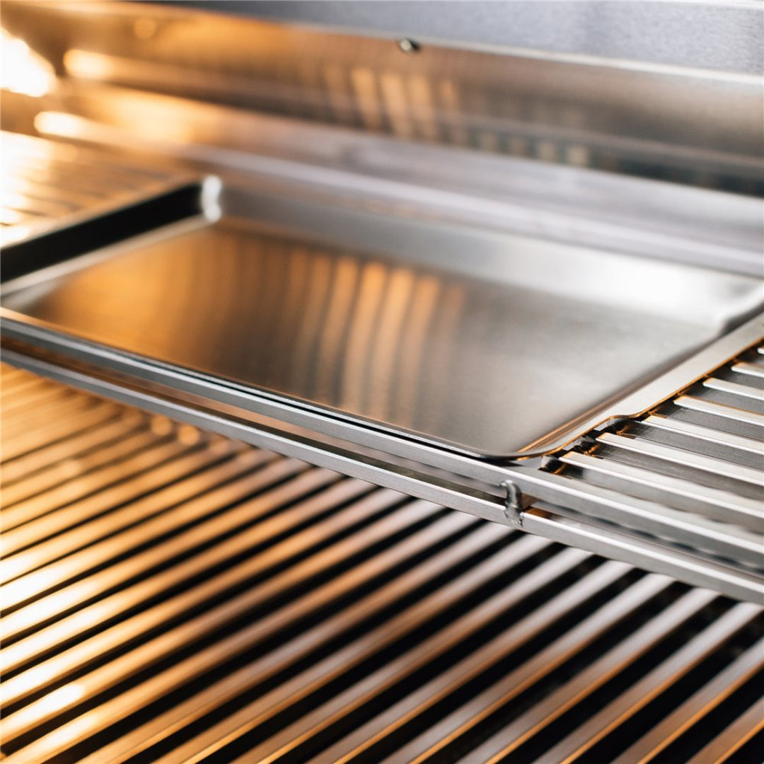 Vine & Flame stainless steel flat griddle pan on gas grill rack — heavy-duty BBQ griddle plate and grease drip tray for searing burgers and vegetables