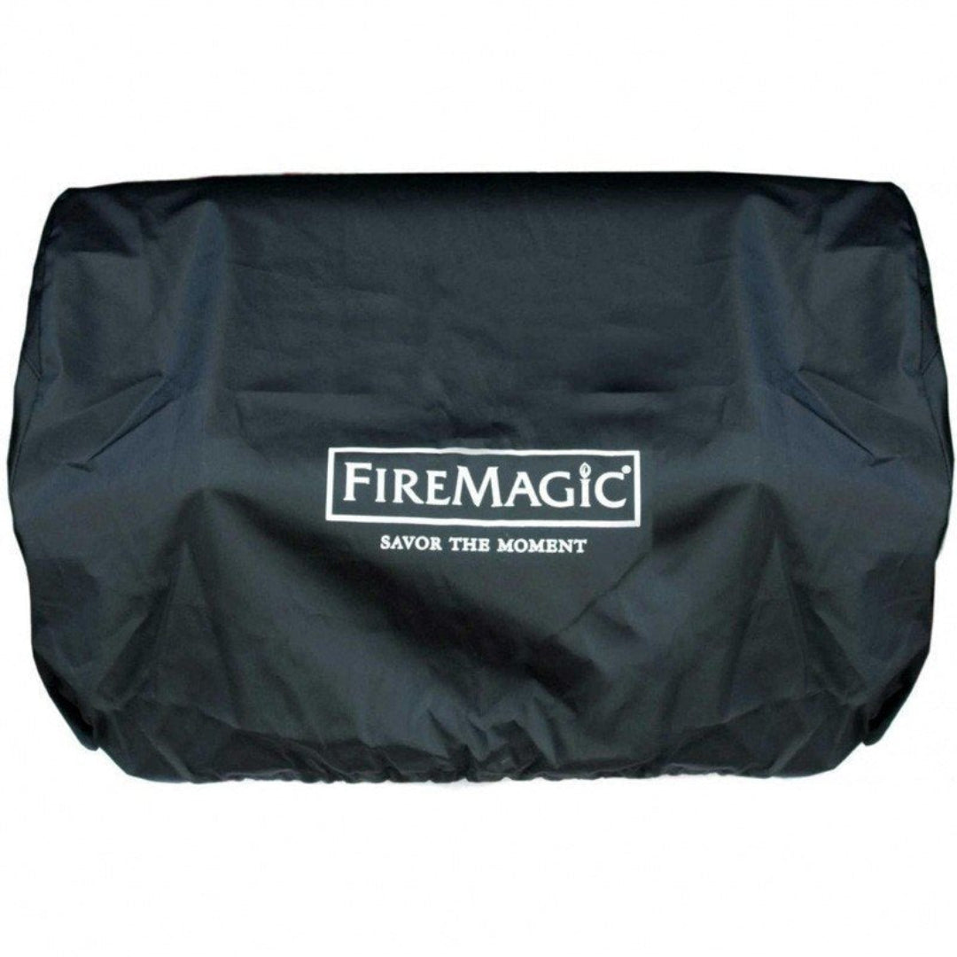 Black FireMagic heavy-duty weather-resistant outdoor grill cover with white FireMagic logo and "Savor the Moment" slogan, protective cover for built-in gas grills