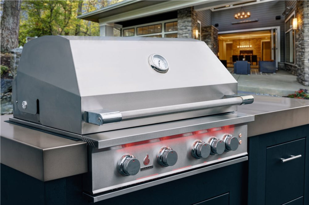 TrueFlame 40-inch stainless steel built-in gas grill with hood thermometer and LED-illuminated control knobs in luxury outdoor kitchen