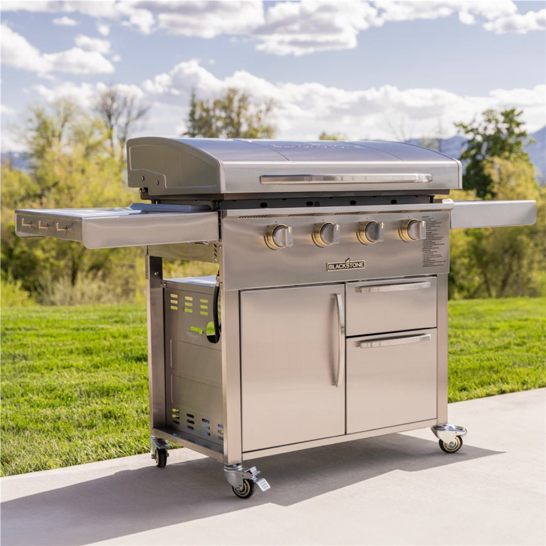 Blackstone Select 36-inch model 6008 stainless steel four-burner flat-top griddle cart with integrated cabinet, side shelves, storage drawers and locking casters, outdoor propane griddle for backyard cooking