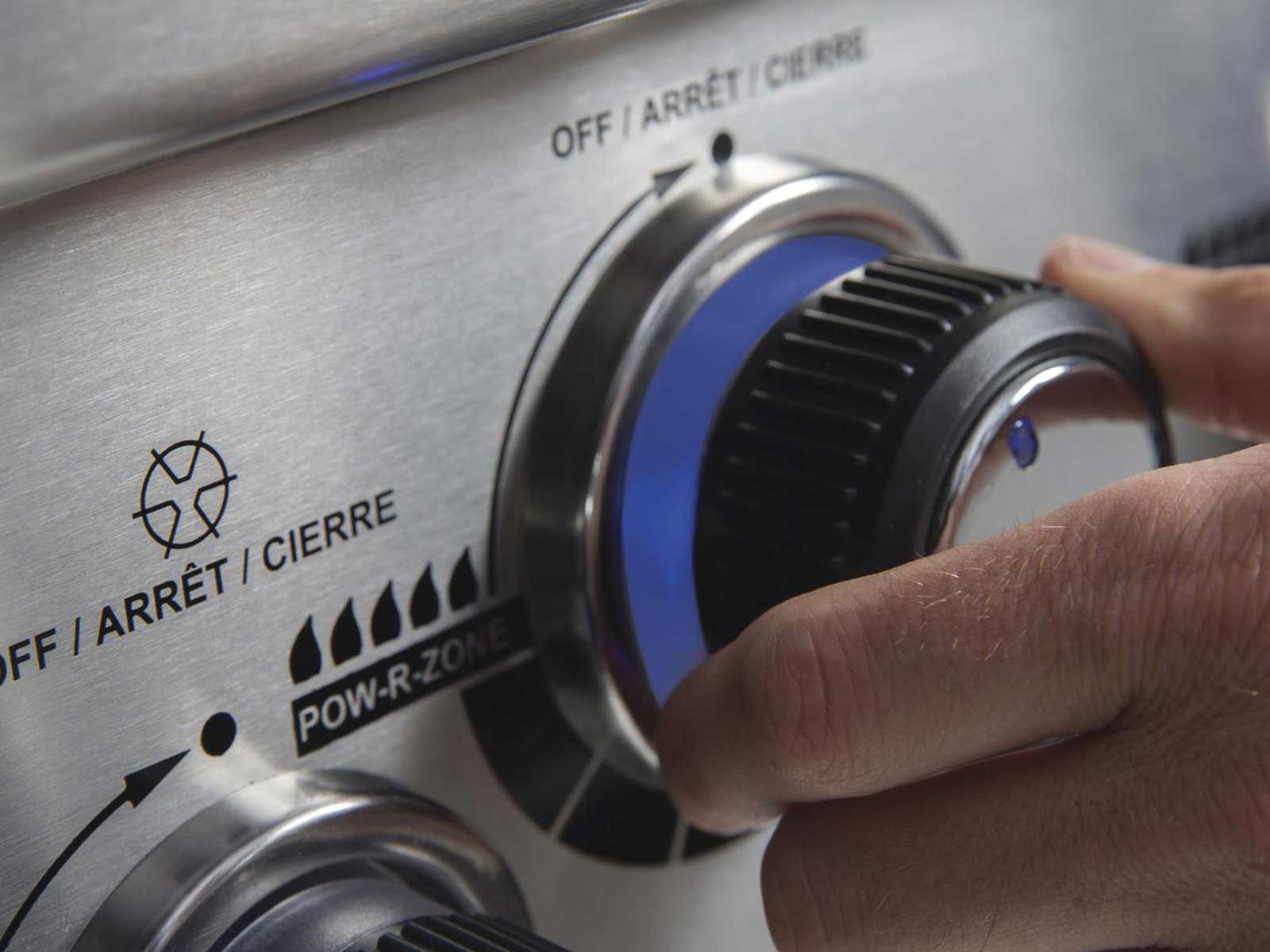 Broil King POW-R-ZONE control knob being turned on stainless steel gas grill