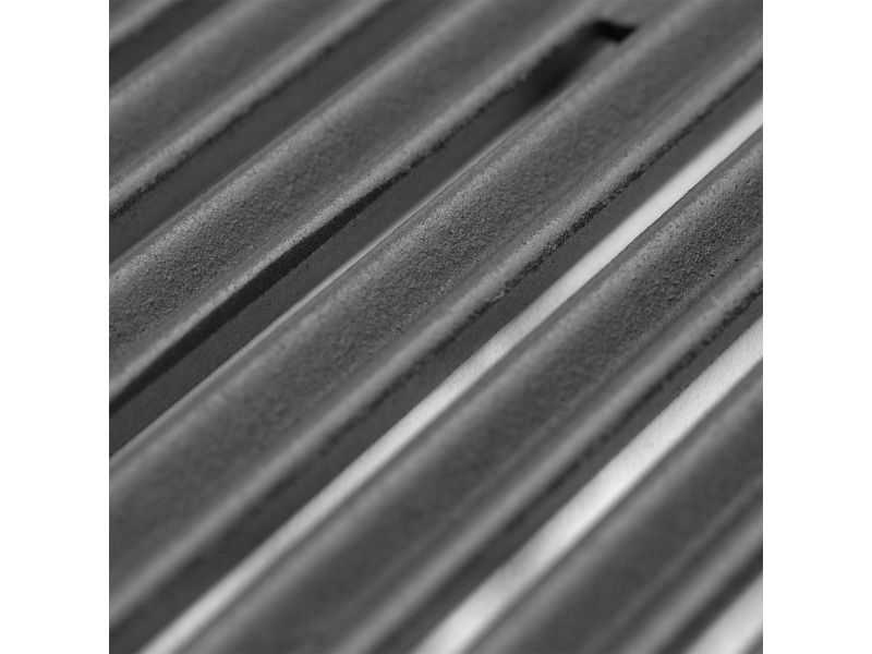 Close-up of cast stainless steel grill cooking grates with textured surface and deep grooves.