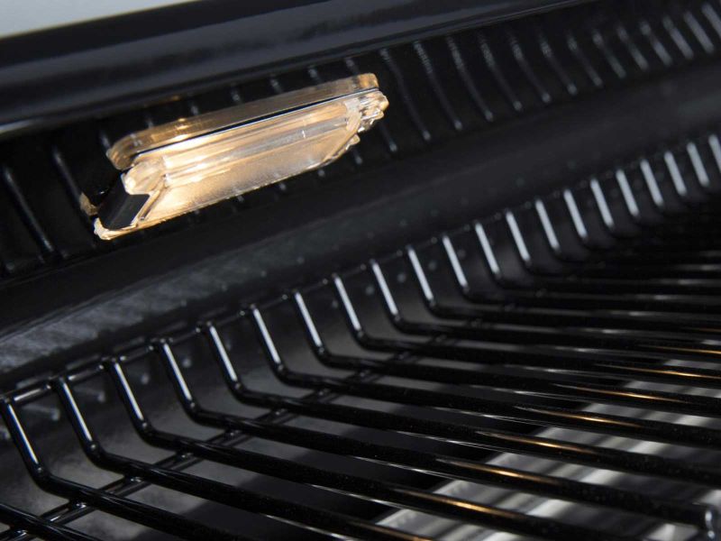 Broil King interior grill light illuminating black cooking grates for night grilling.