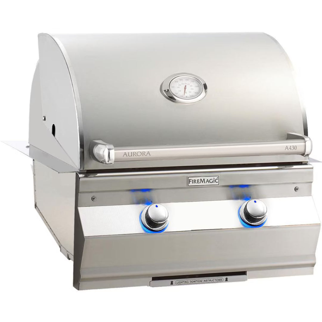 Fire Magic Aurora A430 stainless steel built-in gas grill head with lid thermometer and blue LED-illuminated control knobs for outdoor kitchen