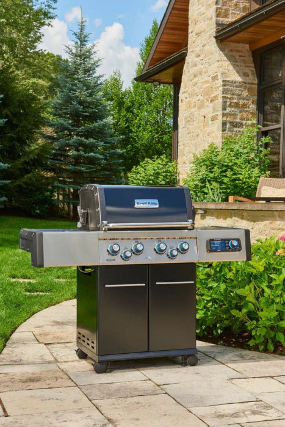 Broil King Regal 490 Pro IR 4-burner stainless steel gas grill on cart with side shelves and infrared rotisserie